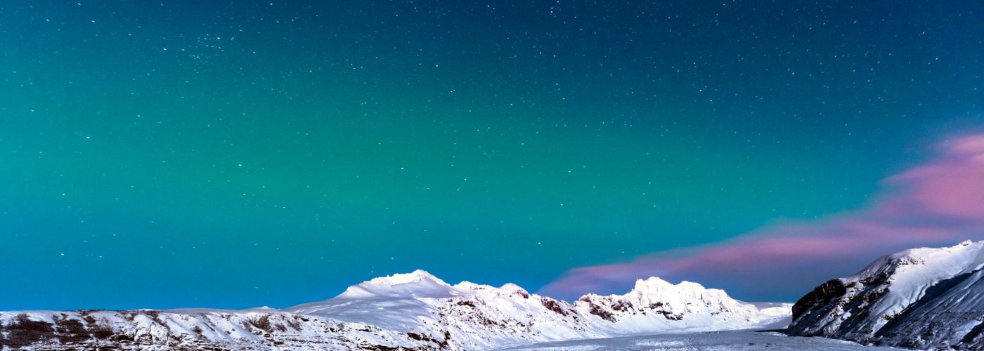 Man taking pictures of amazing view on night starry sky in Iceland, enjoying Northen Lights landscape, active winter traveling, wildlife ladscape photographer